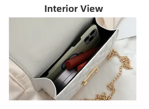 Interior view of white quilted crossbody bag showing storage for phone and cosmetics