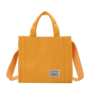 Contrast color canvas tote bag in ginger yellow with top handle and shoulder strap