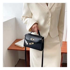 Classic black mini trapezoid handbag with gold metal clasp and top handle for women