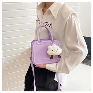 Detail of lavender crossbody bag with fashion text and cute cloud plush charm