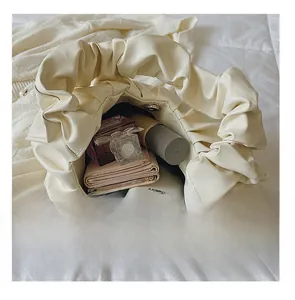 Detail presentation of interior storage capacity for beige pleated cloud shoulder bag