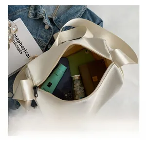 Interior view of white nylon crossbody bag showing spacious capacity for daily essentials