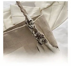 Detail of off-white woven tote bag with printed silk scarf and fashion leather label