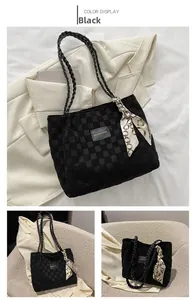 Close-up of black checkered tote bag with woven handles and decorative silk scarf