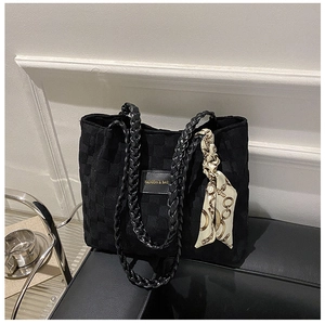 Close-up of black canvas tote with grid texture and elegant printed decorative silk scarf