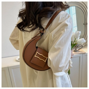Close-up of brown stone-patterned shoulder bag with a stylish large gold hardware buckle