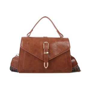Vintage brown leather crossbody bag with colorful woven strap and gold buckle