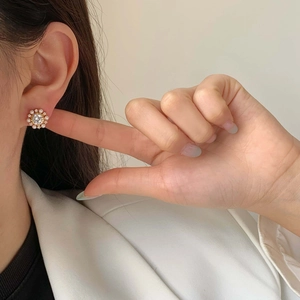 Elegant floral pearl and zircon stud earrings on model for a sophisticated look