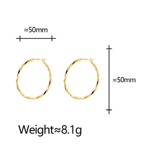 Detail showing 50mm gold geometric spiral hoop earrings with weight specifications