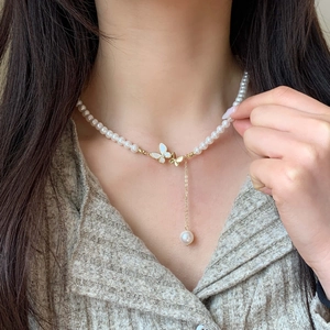 Y-shaped necklace with shell butterfly pendant and hanging pearl on gold chain