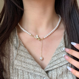Elegant butterfly pearl necklace for women featuring gold and white enamel charms