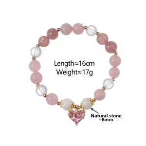 Detailed view of pink strawberry quartz beads and crystal heart pendant on 16cm bracelet