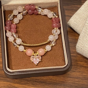 Elegant double-layer pink beaded heart pendant bracelet with gold-tone curved tube