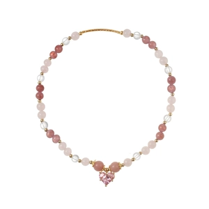 Detailed view of pink heart pendant and colorful beads on a sweet style bracelet