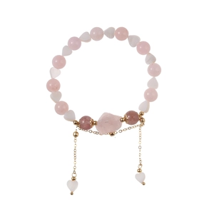 Pink quartz beaded bracelet with heart shell charms and a natural stone center
