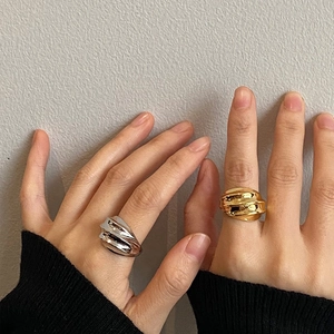 Minimalist textured wavy rings in gold and silver finish with irregular 3D geometric design