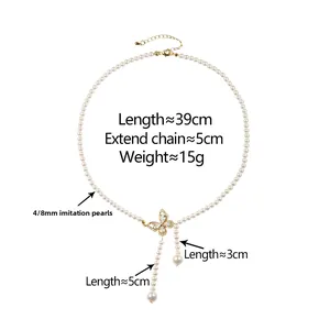 Detail of pearl butterfly necklace with shimmering tassels on a crisp white background