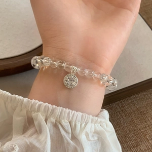 Detailed view of clear crystal bead bracelet with silver pavé cubic zirconia pendant