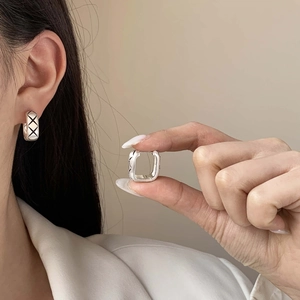 Brushed metal square hoop earrings featuring a black criss-cross quilted pattern