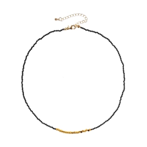 Elegant beaded necklace featuring black faceted stones and gold square accents on white