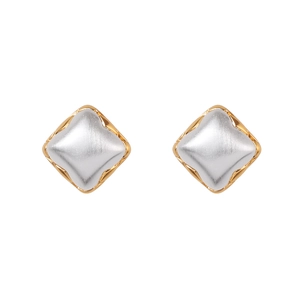 Macro detail of diamond-shaped two-tone stud earrings with matte silver and gold texture