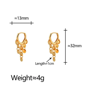 Detalle de pendientes de aro dorados con borlas de lentejuelas con medidas de 32mm por 13mm