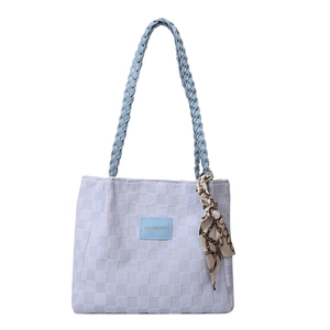 Large lavender tote bag with embossed grid texture and blue woven shoulder straps