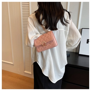 Detailed back view of pink quilted crossbody bag with pearl chain and gold metal clasp