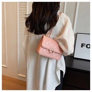 Pink quilted shoulder bag with pearl ring buckle and metal chain shown on model