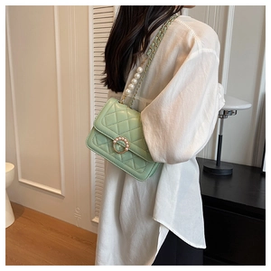 Quilted light green shoulder bag featuring elegant pearl buckle and chain strap detail