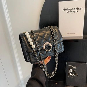 Mini black quilted pearl chain bag with classic diamond pattern and gold hardware strap