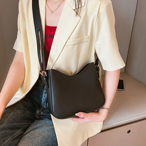 Minimalist black matte leather half-moon shoulder bag with adjustable gold-tone buckle