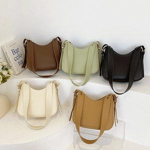 Minimalist hobo shoulder bags in five colors on display stand with tassel detail