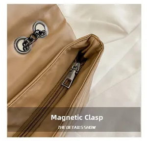 Detail of retro quilted shoulder bag showing magnetic snap closure and metal chain