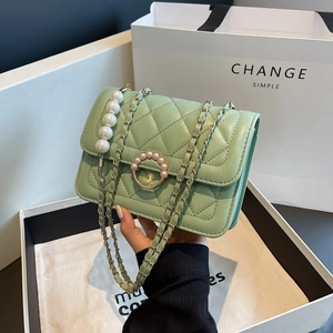 Elegant mint green quilted chain bag with pearl buckle shown in a premium gift setting