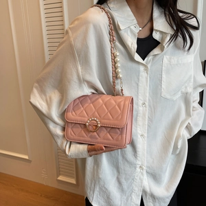 Pink quilted shoulder bag with pearl strap and circular metal clasp for women