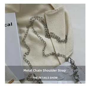 Detail of white floral embossed handbag with durable silver metal chain strap