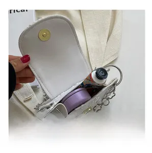 Interior view of white jacquard mini bag showing storage capacity and silver chain