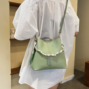 Fashionable light green bucket bag for women with floral silk scarf and metal chain strap