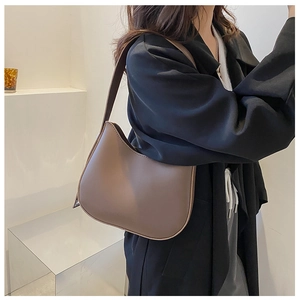 Detail view of a dark brown hobo shoulder bag with matte leather finish and wide strap