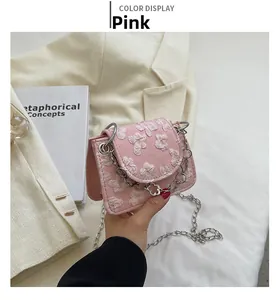 Detailed macro view of pink jacquard fabric with embossed floral texture on mini bag