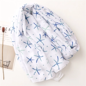 Lightweight cotton linen scarf with blue starfish print and white tassel edges