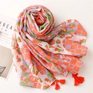 Soft long scarf with orange and green geometric pattern and orange fringe tassels