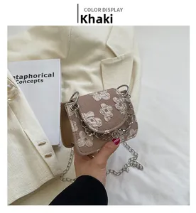 Detail of khaki jacquard mini bag with 3D white flower pattern and silver chain strap