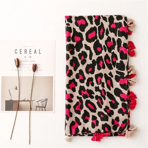 Leopard print scarf with pink accents and bicolor tassels on a white background