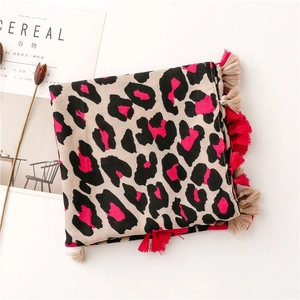 Close-up of leopard print scarf with vibrant pink accents and soft fringe edges