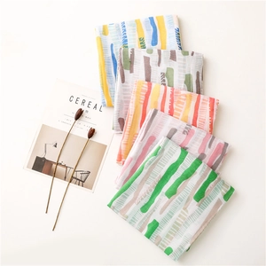 Detailed view of six colorful patterned silk scarves with abstract geometric prints