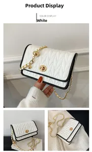 Detail of white quilted crossbody bag featuring gold turn-lock and chain strap texture