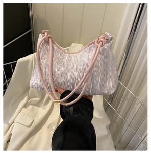 Detail of lavender pleated cloud bag with pink tubular handle and gold hardware