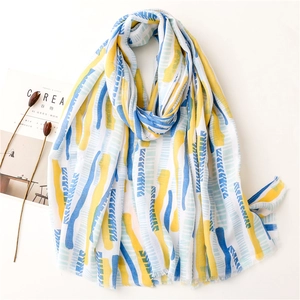Fashionable long sun protection shawl with abstract blue and yellow prints and fringe trim